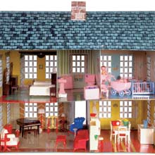Interior of dollhouse with toy plastic furniture.