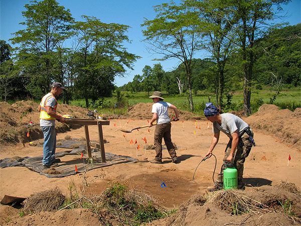 Archaeologists excavate an area