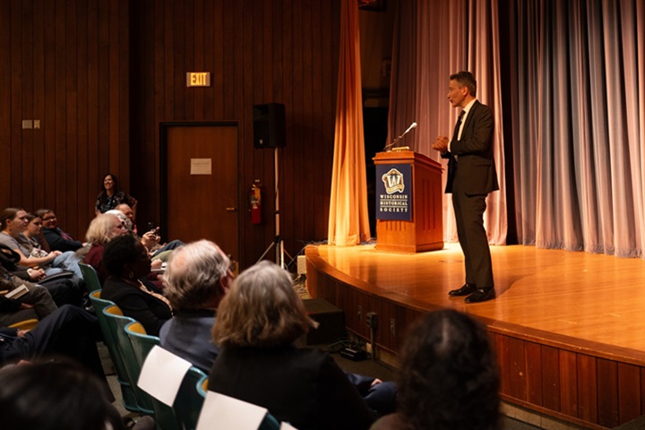 Jeffrey Rosen stands on a stage and addresses an audience