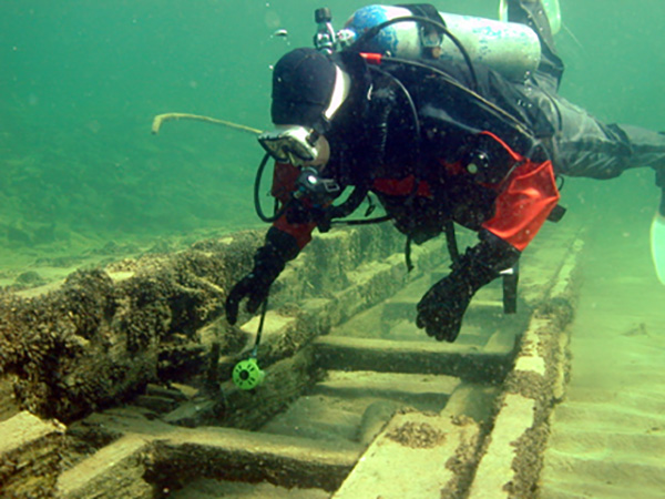 Scuba diver examining a sunken ship