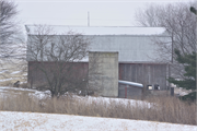 Eastern side of Stockyard Road approximately 0.19-mile northeast of the intersection with Ebenezer Road, a Front Gabled house, built in Wingville, Wisconsin in 1910.