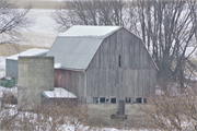 Eastern side of Stockyard Road approximately 0.19-mile northeast of the intersection with Ebenezer Road, a Front Gabled house, built in Wingville, Wisconsin in 1910.