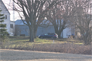 Eastern side of Stockyard Road approximately 0.19-mile northeast of the intersection with Ebenezer Road, a Front Gabled house, built in Wingville, Wisconsin in 1910.