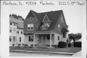 1111 S 8TH ST, a Shingle Style house, built in Manitowoc, Wisconsin in 1895.