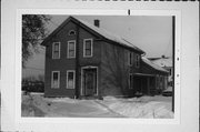 703-703A S 15TH ST, a Greek Revival house, built in Manitowoc, Wisconsin in 1874.