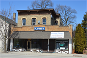 1410 Washington St., a Italianate small retail building, built in Manitowoc, Wisconsin in 1883.
