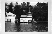 ON LAKE MINOCQUA, 2 MI S OF COUNTY HIGHWAY J, a Queen Anne boat house, built in Minocqua, Wisconsin in 1915.