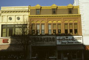 106, 108, 110 W COLLEGE AVE, a Italianate retail building, built in Appleton, Wisconsin in 1880.