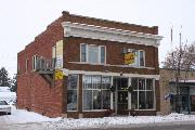 144 W PULASKI ST, a Commercial Vernacular small retail building, built in Pulaski, Wisconsin in 1920.