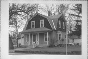 417 5TH ST, a Dutch Colonial Revival house, built in Waupaca, Wisconsin in 1908.