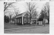124 E MAIN ST, a Greek Revival house, built in Wautoma, Wisconsin in 1858.