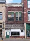 107 N BRIDGE ST, a Commercial Vernacular small retail building, built in Chippewa Falls, Wisconsin in 1886.