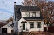 386 ELM ST, a Dutch Colonial Revival house, built in Menasha, Wisconsin in 1921.