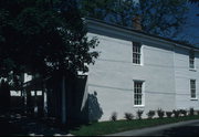 112 6TH AVE, a Greek Revival house, built in New Glarus, Wisconsin in 1859.