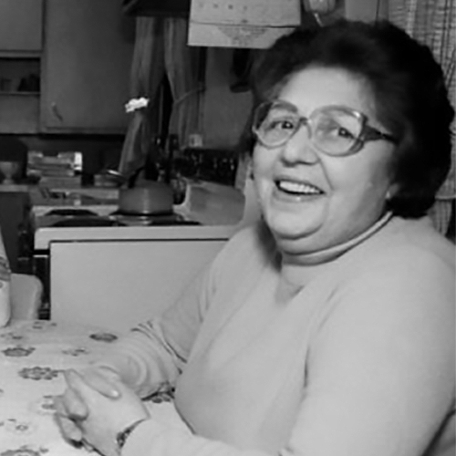 Holocaust survivor Rosa Goldberg Katz in her residence looking quite happy as she sits at her table.