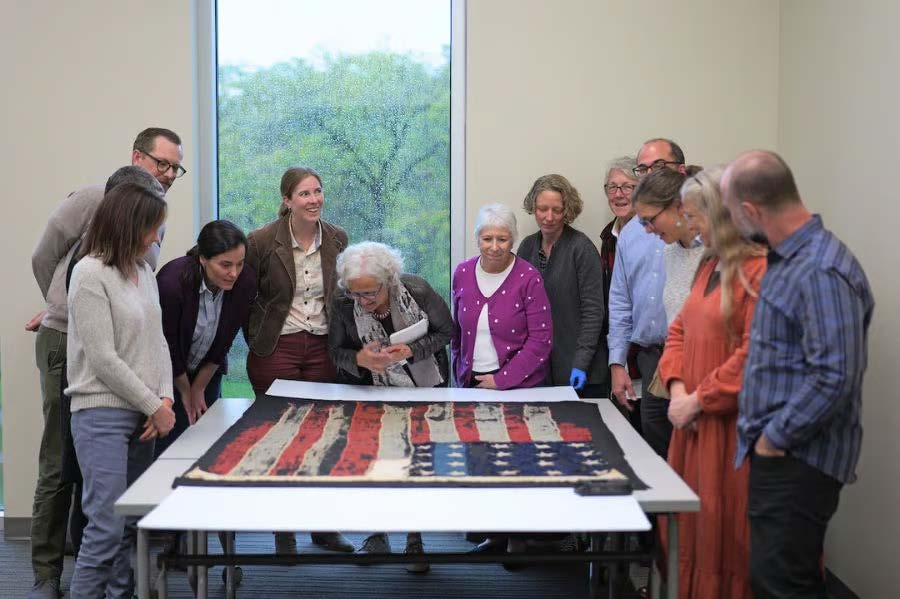 A group gathers around a collections object.