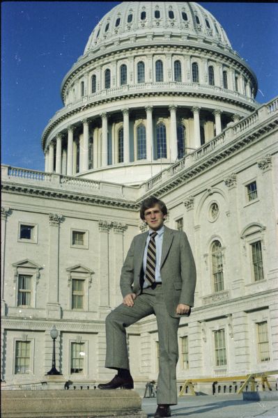 Steve Gunderson posing outdoors in front of the U.S. Capitol building.