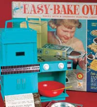 Blue easy bake oven toy with plastic red bowl.